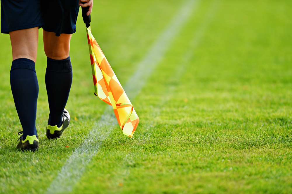 Soccer referee with flag