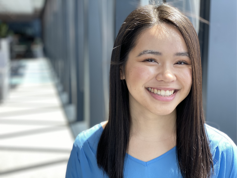 Jasmine Nguyen profile. She has dark hair, worn out and is wearing a blue shirt.