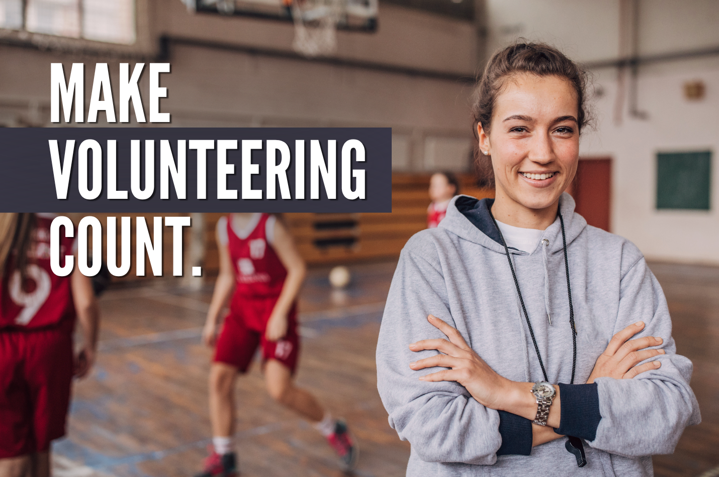 A volunteer basketball coach, standing in a gym with her arms crossed and smiling. Text reads